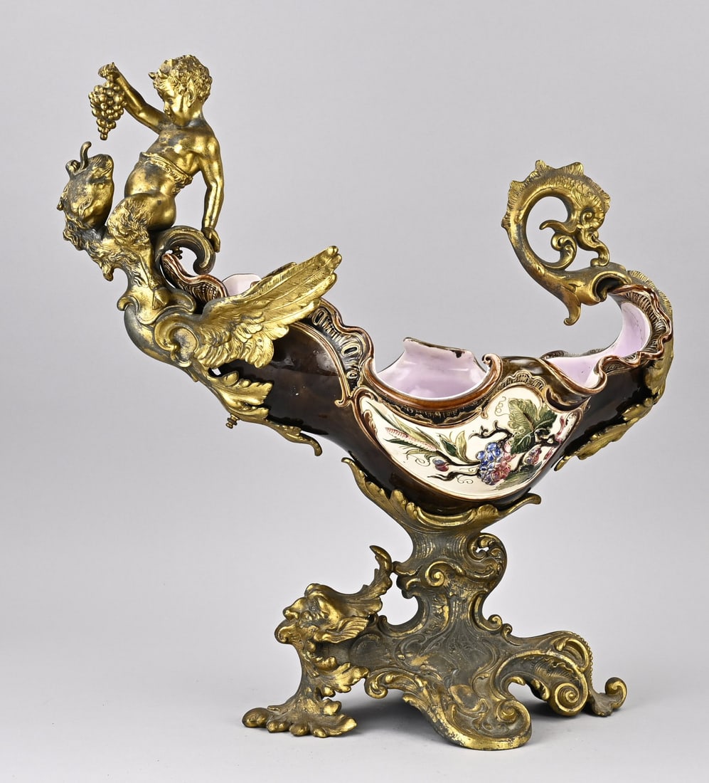 Majolica ceremonial bowl, 1880: Beautiful antique majolica display bowl with gilded metal bacchus, phoenix and fratz. Historicism pure! Circa 1880. Dimensions: 48 x 45 x 24 cm. In good condition.