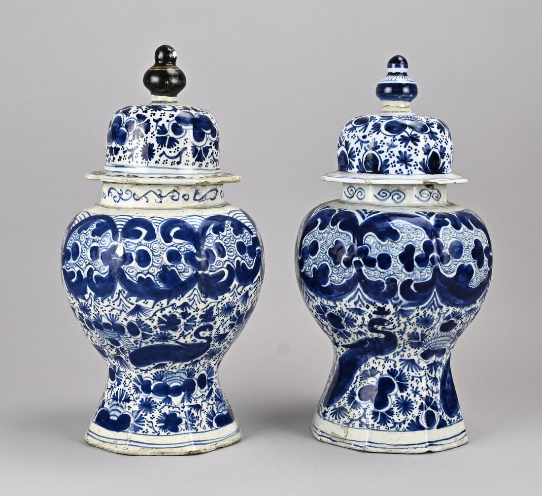 2x Delft lidded pot: Two 18th-century Delft faience lidded jars with floral/peacock decoration. Rim damage. Restoration. Dimensions: H 37 cm. In fair/good condition.