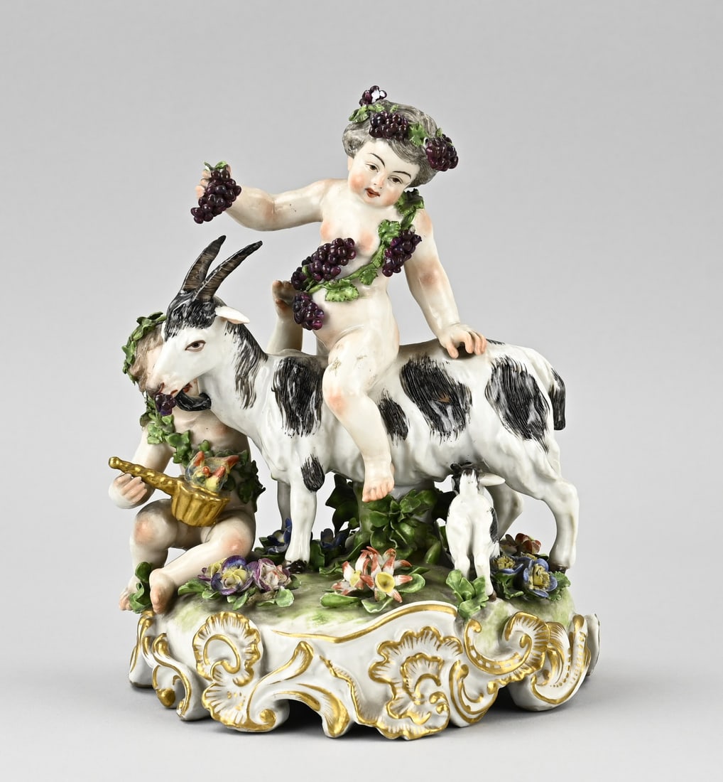 18th-century porcelain figurine, 21 cm.: Beautiful 18th-century porcelain figure group with a goat, Bacchuses, and floral/gold decoration. Indistinct sword mark. Dimensions: 21 cm. Some damage to the flowers. In reasonable condition.