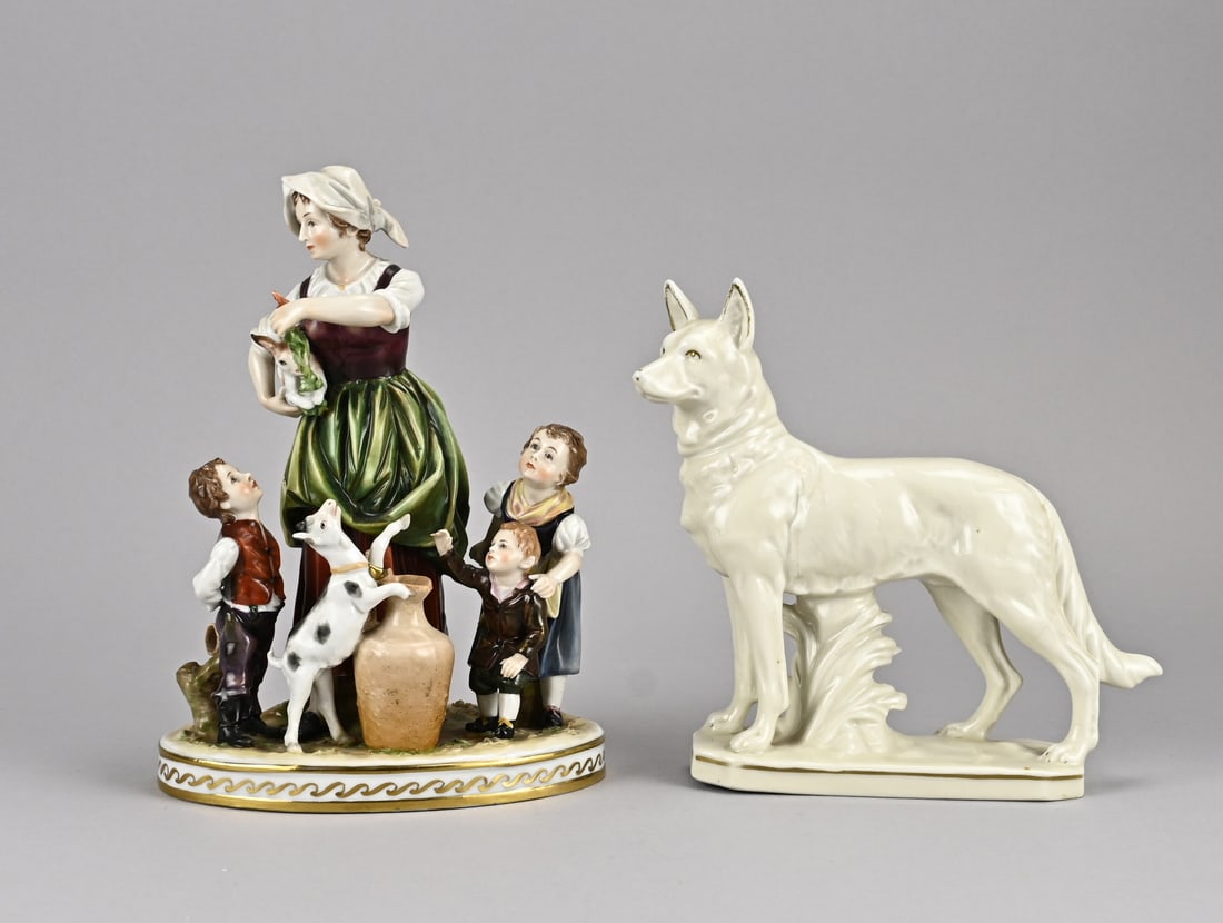 2x Porcelain figure: Two old porcelain figures. Germany. 1x Figure group, marked with a crown and an A underneath, goat's leg damaged, circa 1900. 1x Shepherd dog, Kunat Porzellan, circa 1930 - 1940. Dimensions: 17 - 22 c