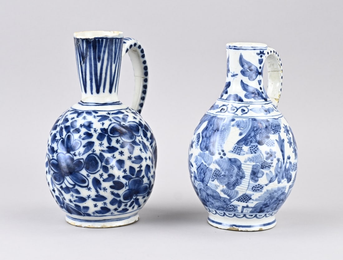 2 Parts Delft: Two antique Delft faience pitchers. 18th century. Base mark. Dimensions: H 20 - 21 cm. In fair/good condition.