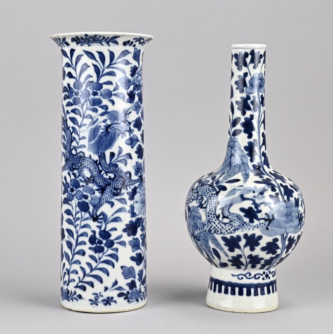 2x Chinese vase, H 25.5 - 26 cm.: Two 19th-century Chinese porcelain vases. 1x Pipe vase with dragon decoration + six-character base mark, good. 1x Cylinder vase, floral/dragon decoration, four-character base mark, rim damage.