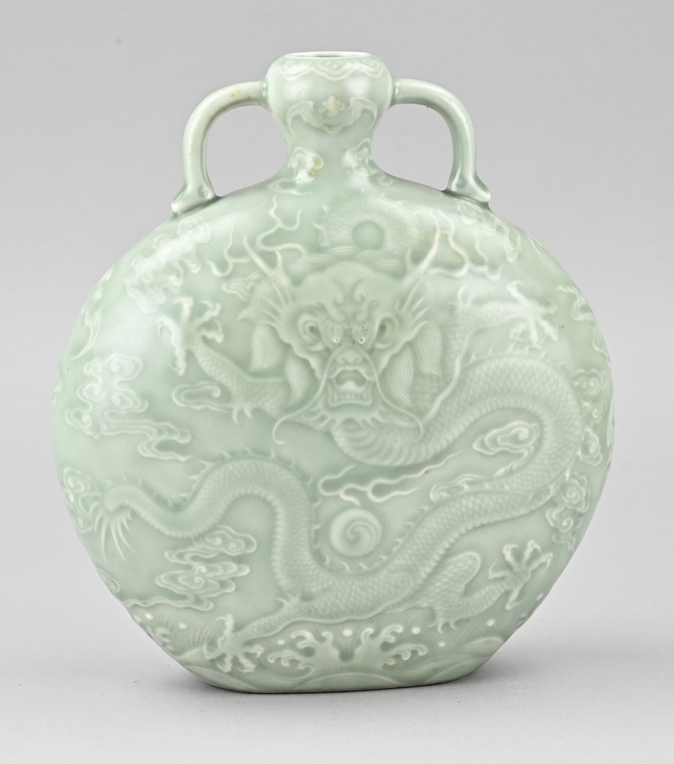 Celadon moon vase, H 23 cm.: Chinese porcelain celadon moon vase with relief dragon decor. Bottom mark. Dimensions: H 23 cm. In good condition.