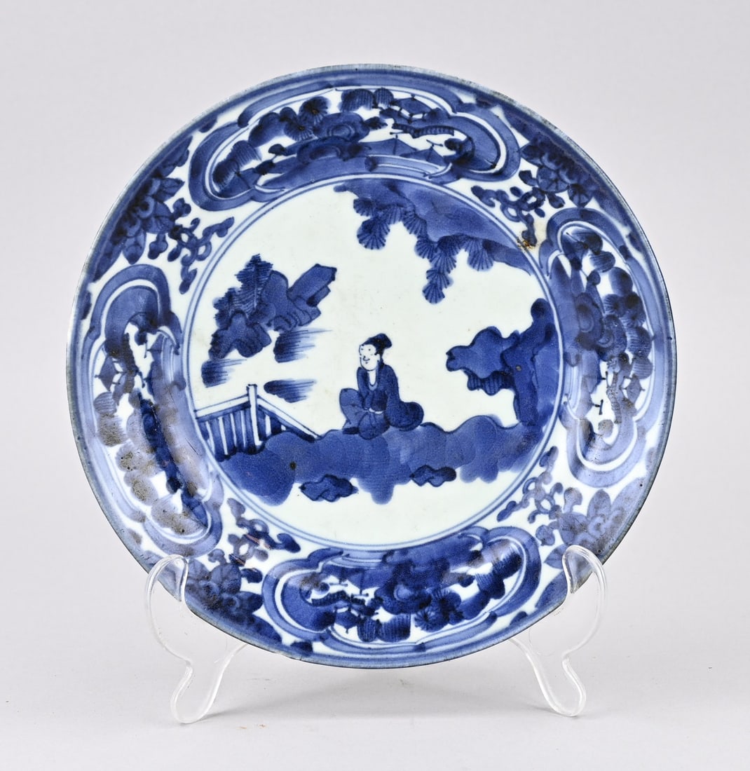 Japanese Arita plate, Ø 21.5 cm.: Antique Japanese porcelain Arita plate with figure in garden decor. Circa 1700. Dimensions: Ø 21.5 cm. In good condition.