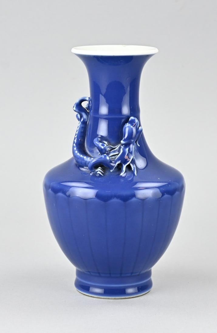 Chinese vase, H 22.5 cm.: Chinese porcelain dragon vase with blue (transparent) glaze and relief. 1x Rim restoration. Dimensions: H 22.5 cm. In reasonable condition.