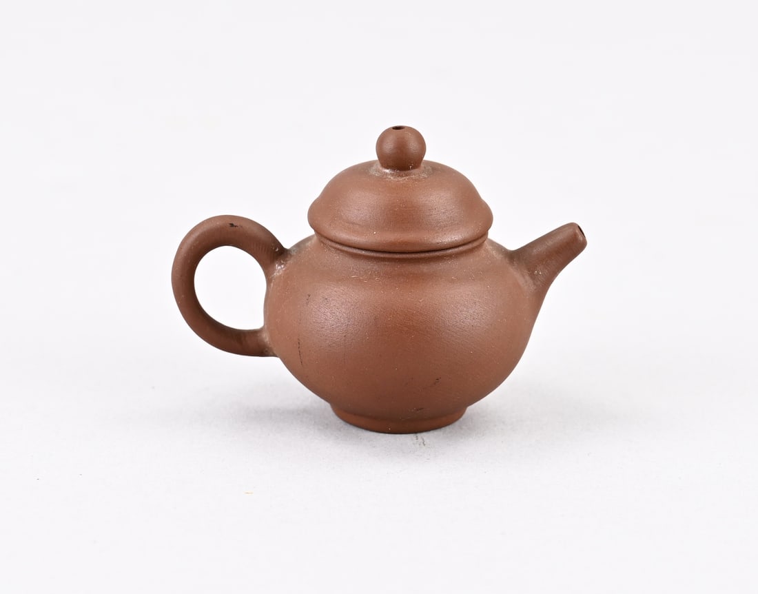 Chinese miniature teapot: Small, old, Chinese miniature Yixing teapot. Dimensions: 7 x 4.2 x 4.8 cm. In good condition.