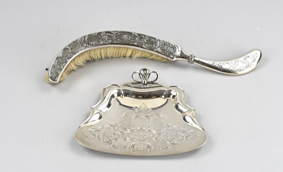 Silver dustpan and brush: Silver dustpan and brush, 833/000, richly decorated with floral engraving. Maker: Widow G. Stellingwerf-Voorthuis and AB van Glasstek, Amsterdam. Year: P:1849. Shop mark Bonebakker and son. A few