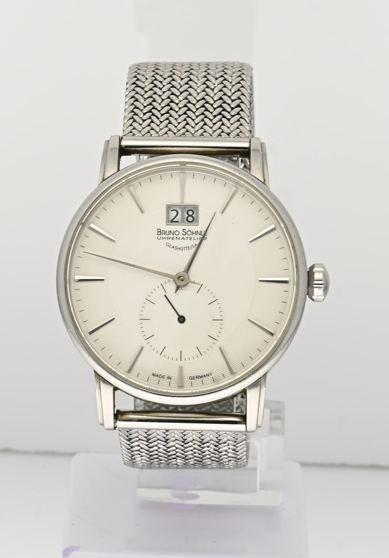Bruno Söhnle Glasshutte watch: Bruno Söhnle Glashutte watch, Quartz, with a round steel case featuring a decentralized seconds hand and a date display. The watch is fitted with a braided steel bracelet. Features an opening window