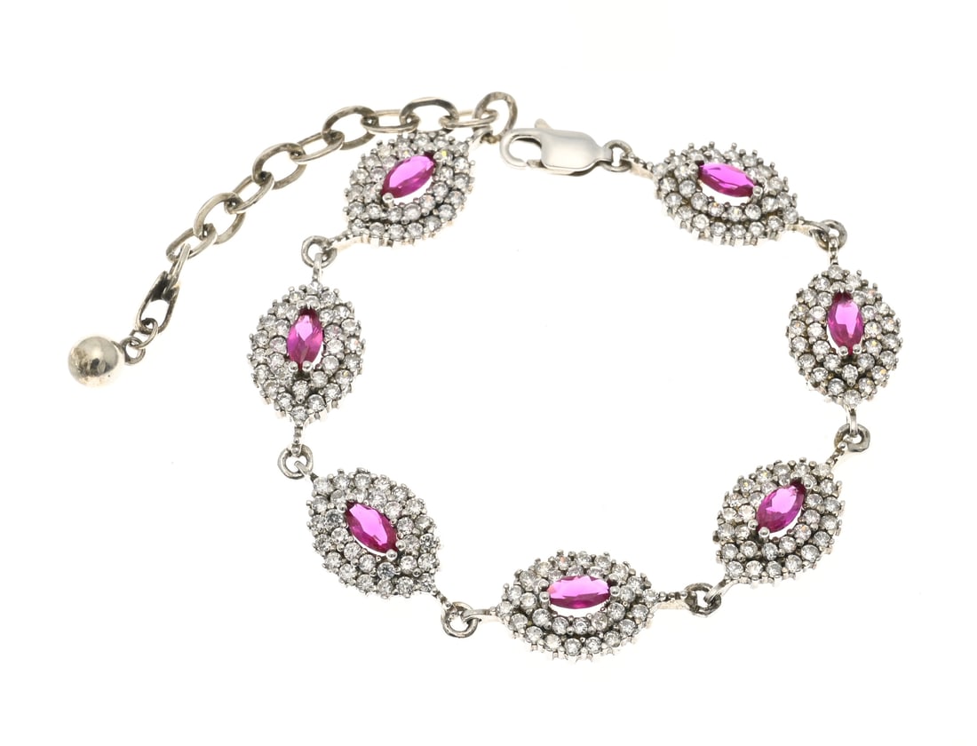 Silver bracelet with cubic zirconia and ruby: Silver bracelet, 925/000, with marquise-shaped links set with a marquise-cut ruby in the center and surrounded by a double border of cubic zirconia. Width 10 mm. Length 15.5-20.5 cm. Approx. 12