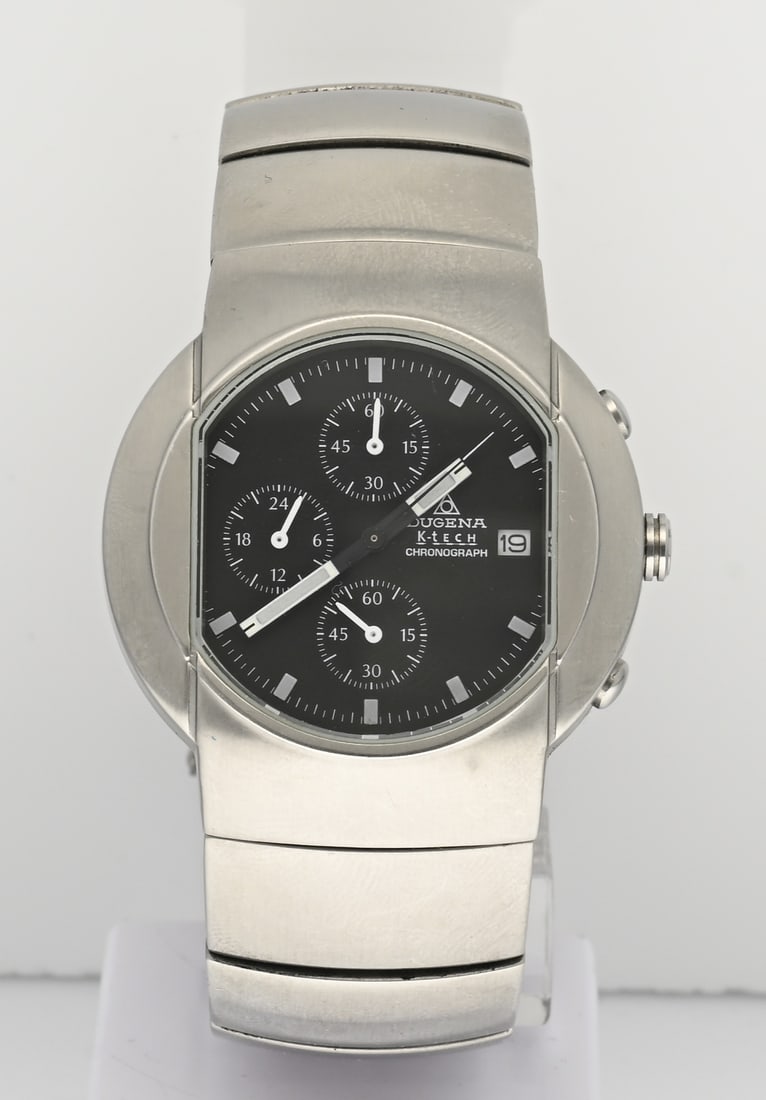 Dugena K-tech watch: Dugena K-tech watch, steel model with a chronograph with autoquartz technology. Features a black dial and a steel case and bracelet. ø 39 mm. Case number: 2157393. In very good condition.