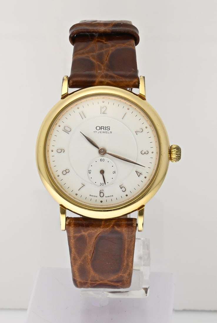 Oris double leather watch: Oris unisex watch, gold-plated, mechanical, featuring a white dial with a decentralized seconds hand. Case diameter 34 mm. Case number 7423. Mounted on a brown leather strap. Working. In very good