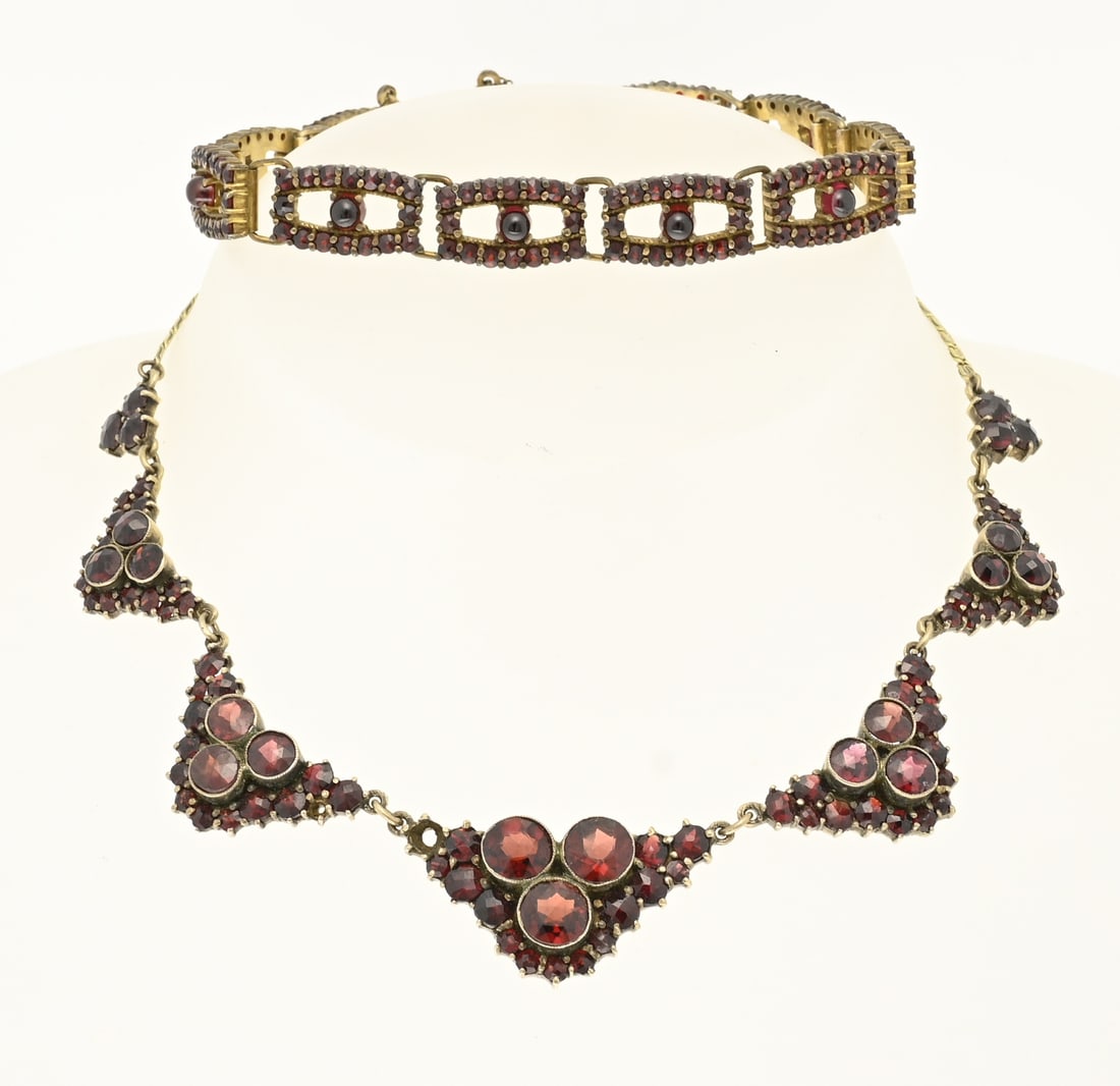 Choker and bracelet with garnet: Gold-plated silver choker and bracelet with garnets. Choker with 7 V-shaped elements decorated with garnets and a bracelet with rectangular links, set in the center with a cabochon-cut garnet and a