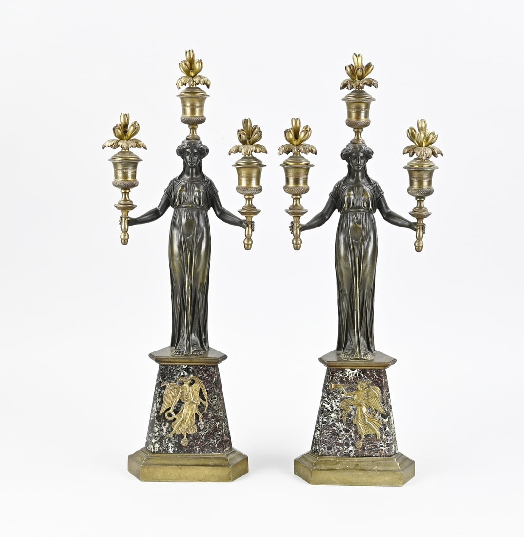 2x 19th-century French candlesticks, H 48 cm.: Two candlesticks in Empire style, with Greek ladies and floral bobeches. France. 19th century. Dimensions: H 48 cm. In good condition.