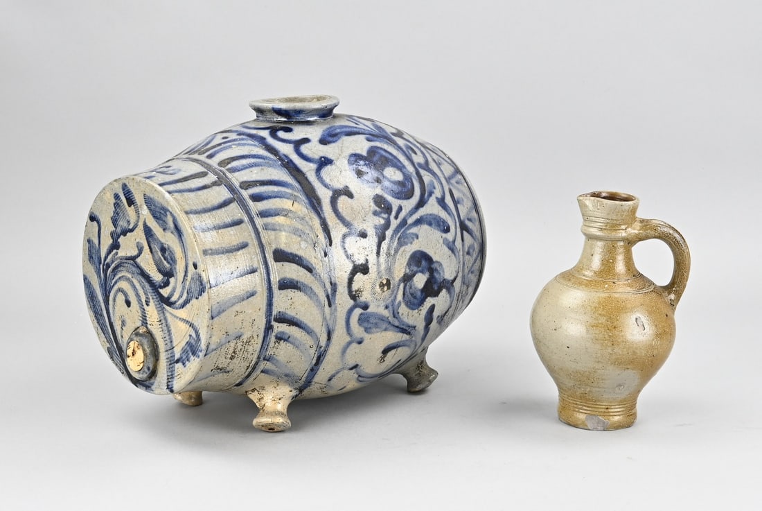 2x German stoneware: Two pieces of antique German stoneware. 1x Raeren jug, 17th century. 1x Westerwald liquor vessel, 18th century. Dimensions: 18 x 30.5 cm. In good condition.
