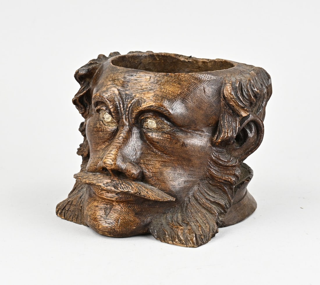 Swiss tobacco pot: 19th-century Swiss oak carved tobacco jar with decoration of a man with a moustache. Lid is missing. Dimensions: 12 x 15 x 15 cm. In good condition.