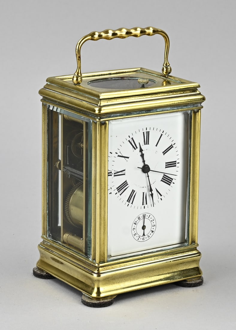 French travel alarm clock, 1890: Antique, rare, intact bronze-gilt French travel alarm clock with quarter-hour strike + alarm. With central seconds hand. Eight-day movement. Circa 1890. In working condition. Dimensions: 15 x 9.5 x