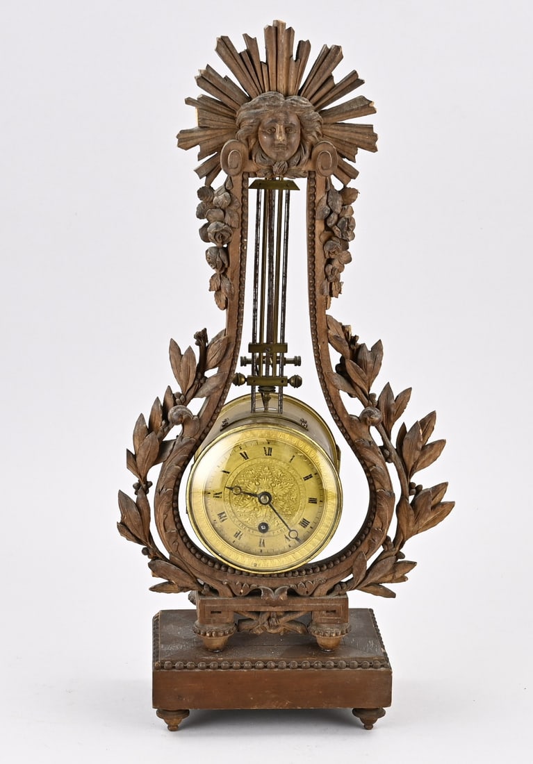 Lyra pendulum, 1820: Antique French Louis Seize carved wood lyra pendulum. Arera Paris. Circa 1820. Dimensions: H 48 cm. Winding spring defective, otherwise in good condition.