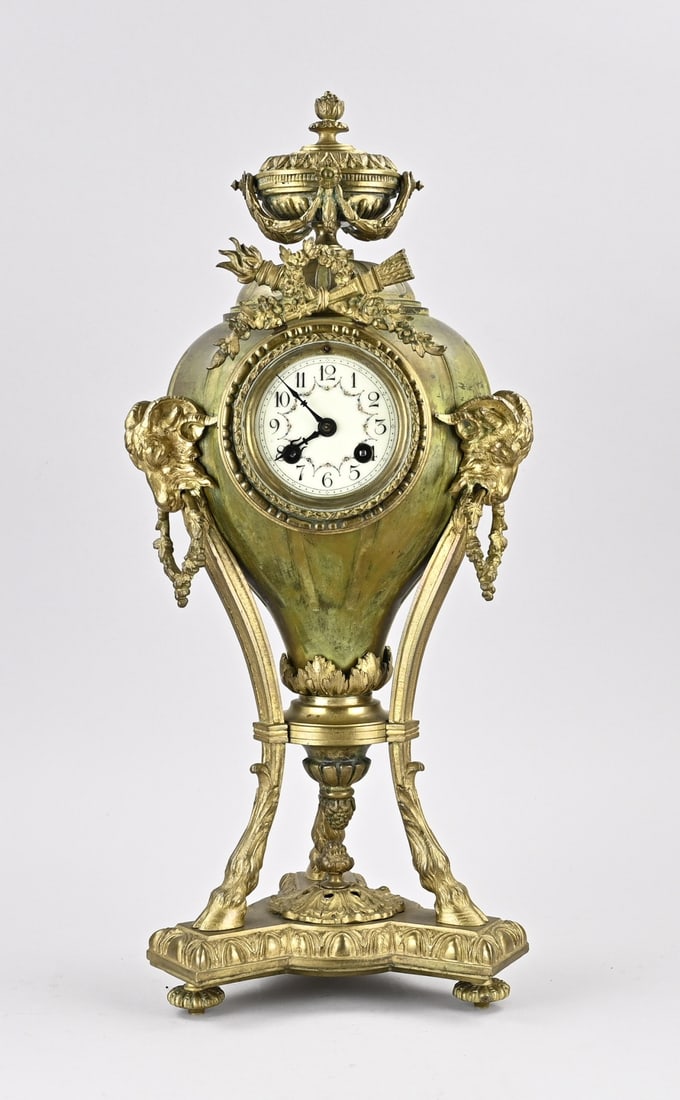 French pendulum clock, H 53 cm.: Antique French gilded bronze pendulum clock with ram's heads, goat's feet, and balloon-shaped garlands. Circa 1880. Eight-day movement, half-hour strike. Dimensions: H 53 cm. In good condition.