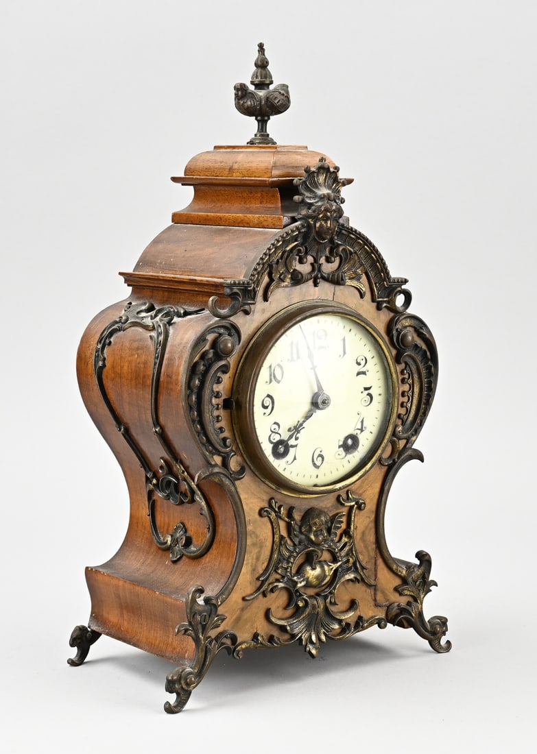 German table clock, H 36 cm.: Antique German table clock in burr walnut with original bronze fittings. 1 Million 217229. Circa 1890. Eight-day movement, half-hour strike. Dimensions: H 36 cm. In good condition.
