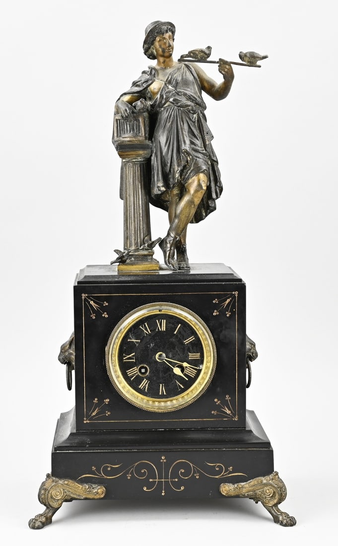 French clock, 1890: Antique, French, black marble clock with figure and turtledoves. Metal composition. Circa 1890. Eight-day movement, half-hour strike, spring pendulum. Dimensions: 53 cm. In good condition.