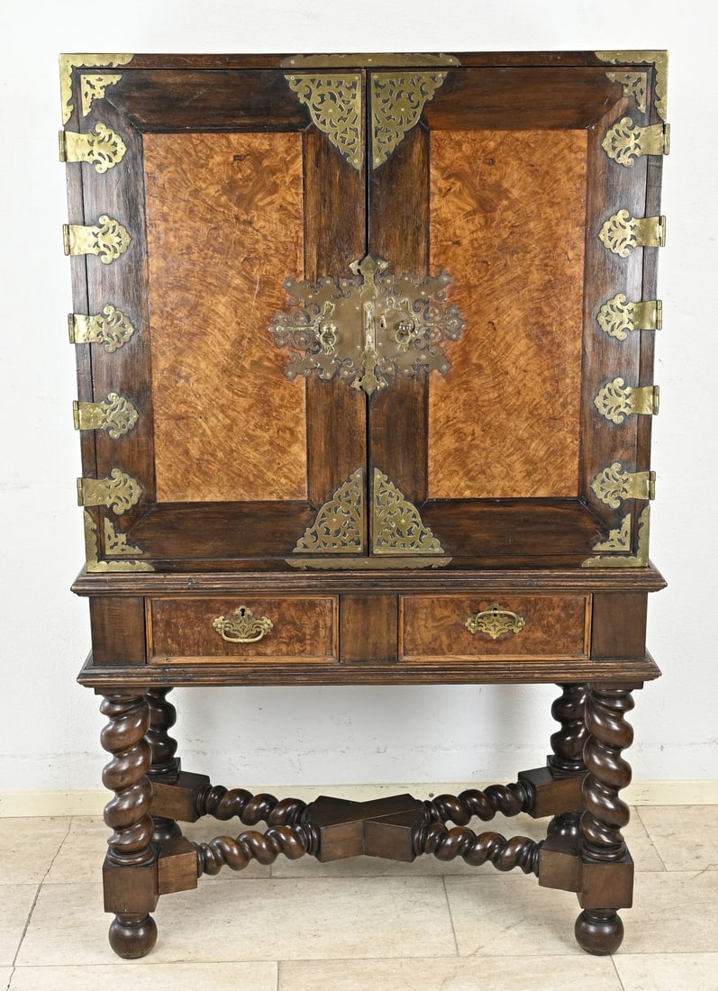 Colonial cabinet (cross-foot): 19th-century, two-part, colonial teak cross-base cabinet with burr wood panels, bronze fittings/decorations, and many drawers. Dimensions: 160 x 103 x 52 cm. In good original condition.