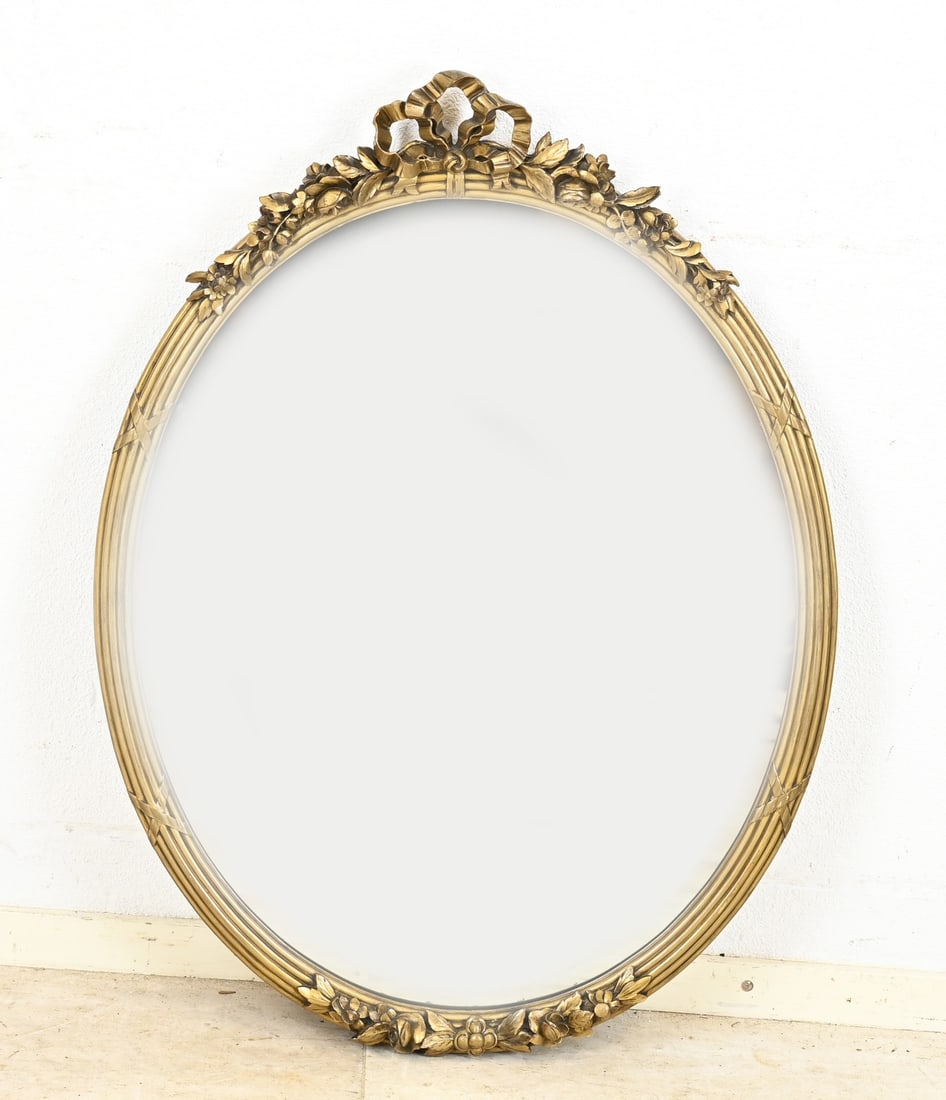 Gold-colored mirror, 85 x 65 cm.: Old gold-colored mirror with floral carving and beveled edge. 20th century. Dimensions: 85 x 65 cm. In good condition.