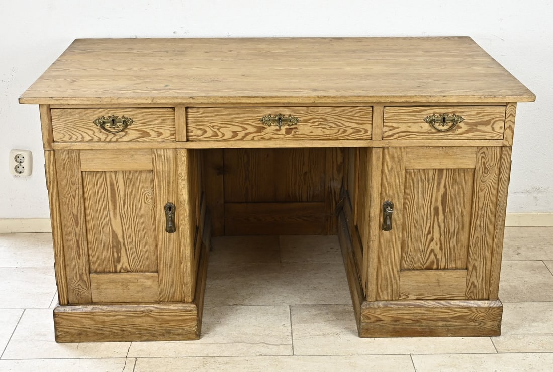 Antique writing desk, 1900: Antique German pine writing desk with three drawers and two doors. Circa 1900. Dimensions: 75 x 140 x 80 cm. In good condition.
