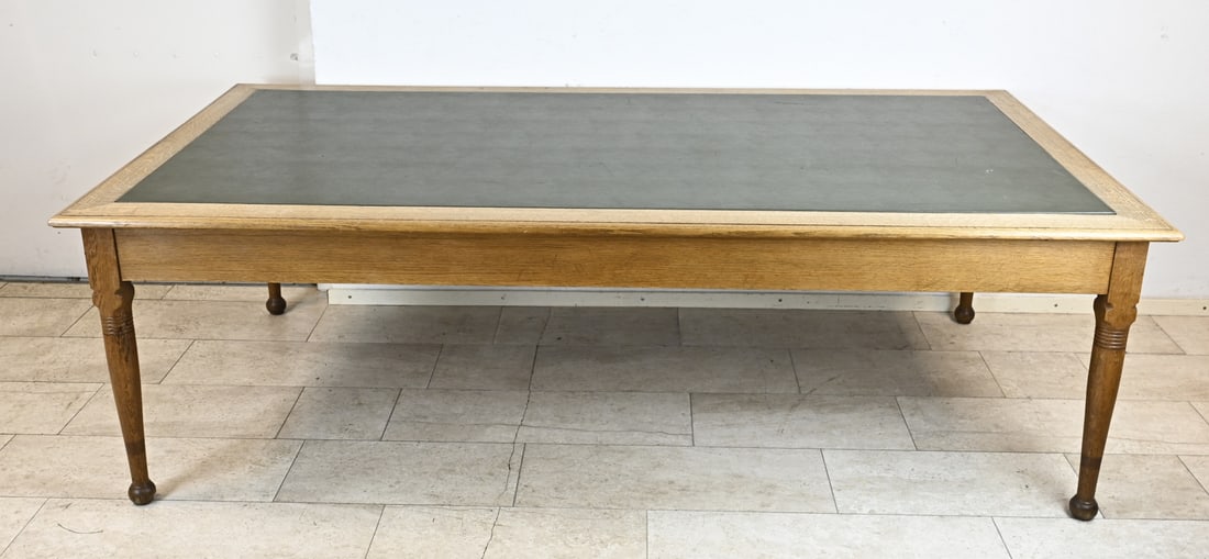 Large conference table, 1900: Antique oak conference table, originating from the Breda courthouse. Circa 1900. The top is covered with green faux leather. Dimensions: 79 x 249 x 129 cm. In good condition.