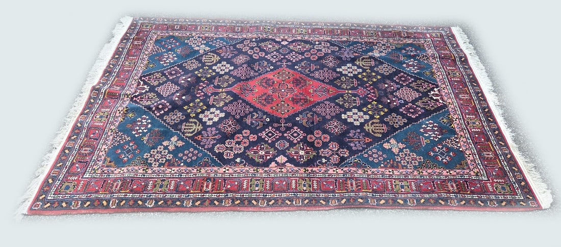 Persian rug, 250 x 166 cm.: Old Persian rug with decoration of plant and tree motifs. Color: green/red/black/cream. Dimensions: 250 x 166 cm. In good condition.