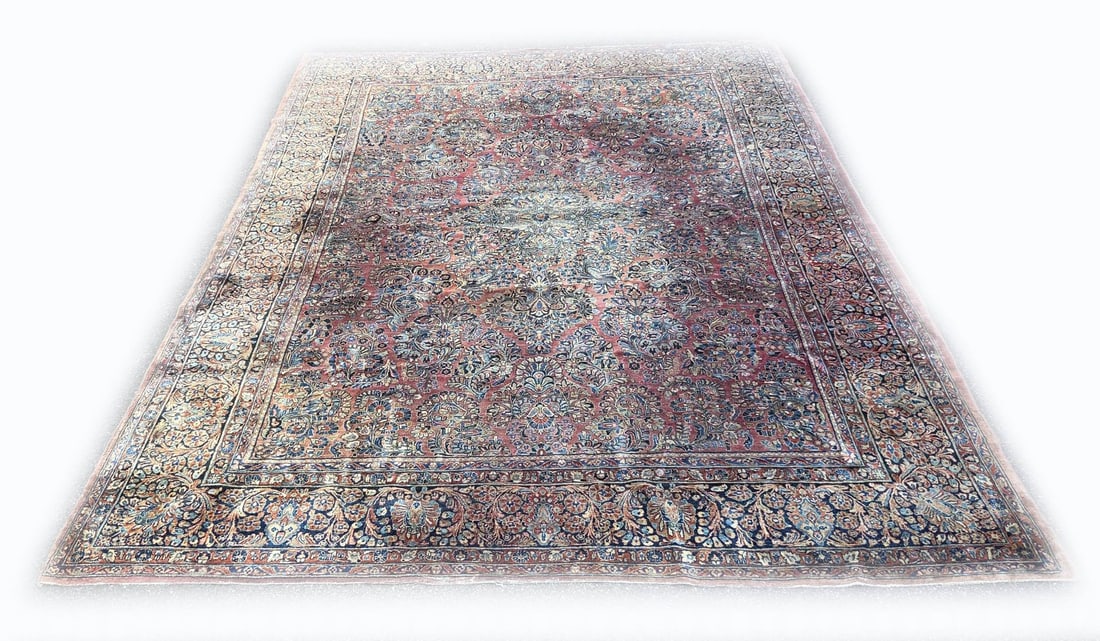 Persian rug, 410 x 310 cm.: Very large antique hand-knotted Persian rug. Color: red, with decoration of flowers and medallions. Dimensions: 410 x 310 cm. In fair/good condition.