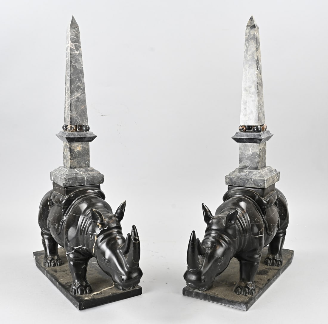 Set of images, Rhinos: Two large and heavy marble rhinoceroses with obelisks. Art Deco style. 20th century. Dimensions: 33 x 15 x 60 cm. In good condition.