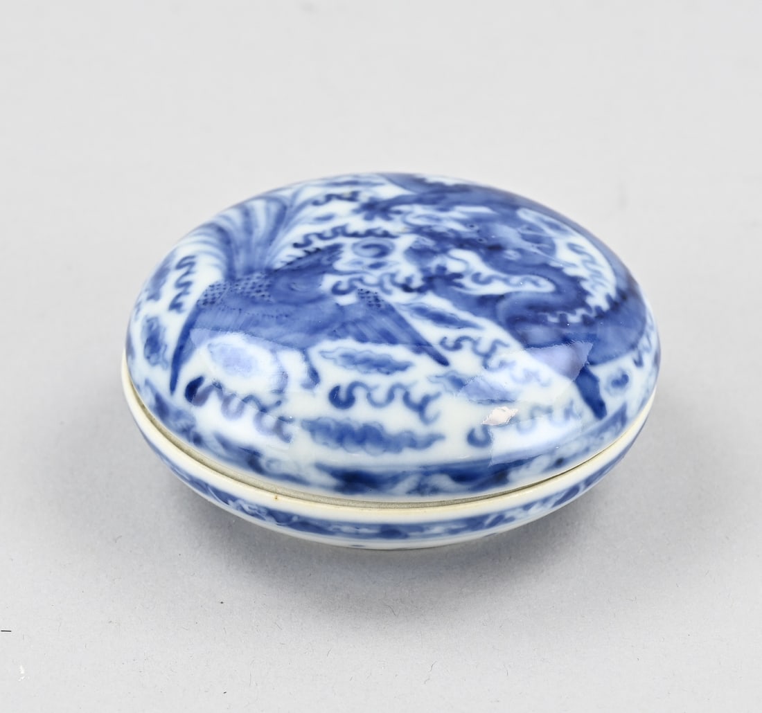 Chinese lidded box: Old Chinese porcelain lidded box with phoenix and dragon decoration. Base mark. Dimensions: 3.7 x 8.4 cm. In good condition.