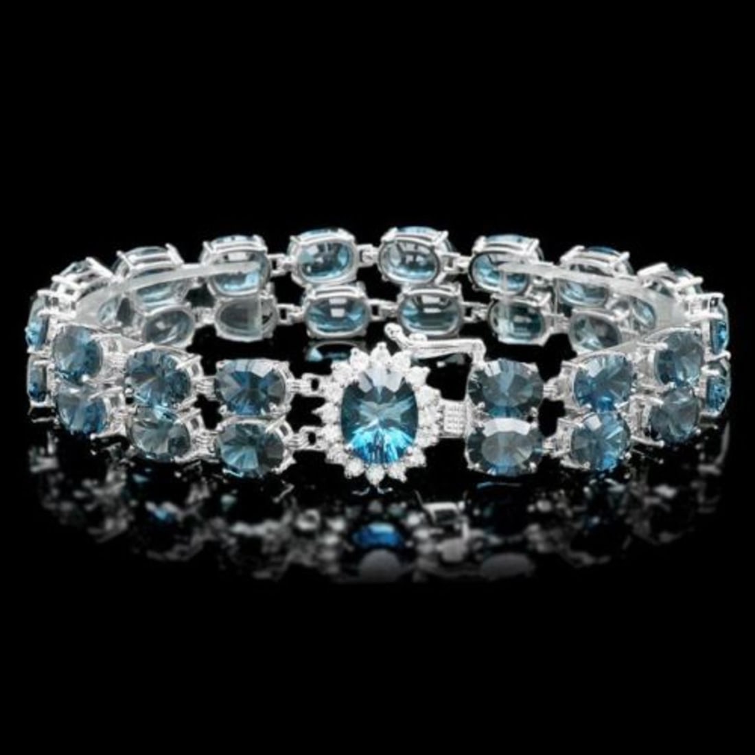 14K Gold 48.69ct Blue Topaz 0.57ct Diamond Bracelet: Retail: $14,000.00 ****** 14K Gold 48.69ct Blue Topaz 0.57ct Diamond Bracelet ****** Metal: 14K White Gold / Total Item Weight: 26.0 Grams / Country Made: United States / / Main Stone: Blue Topaz /