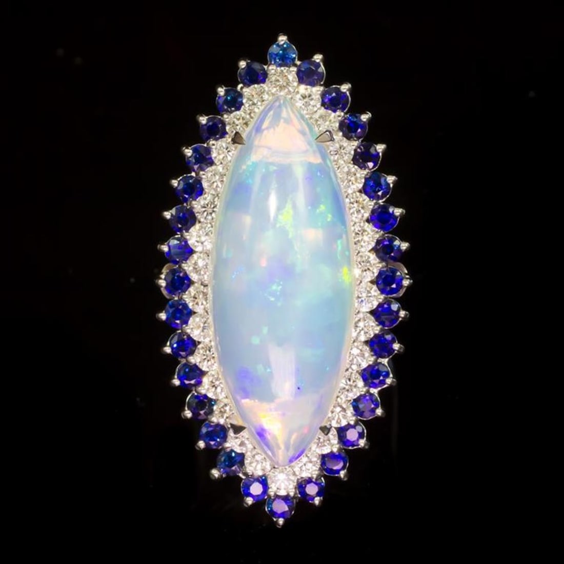 14K White Gold 15.65ct Opal 1.17ct Sapphire and 1.89ct Diamond Ring: Retail: $16,550.00 ****** 14K White Gold 15.65ct Opal 1.17ct Sapphire and 1.89ct Diamond Ring ****** Metal: 14K White Gold / Total Item Weight: 17.8 Grams / Country Made: United States / / Main Stone: