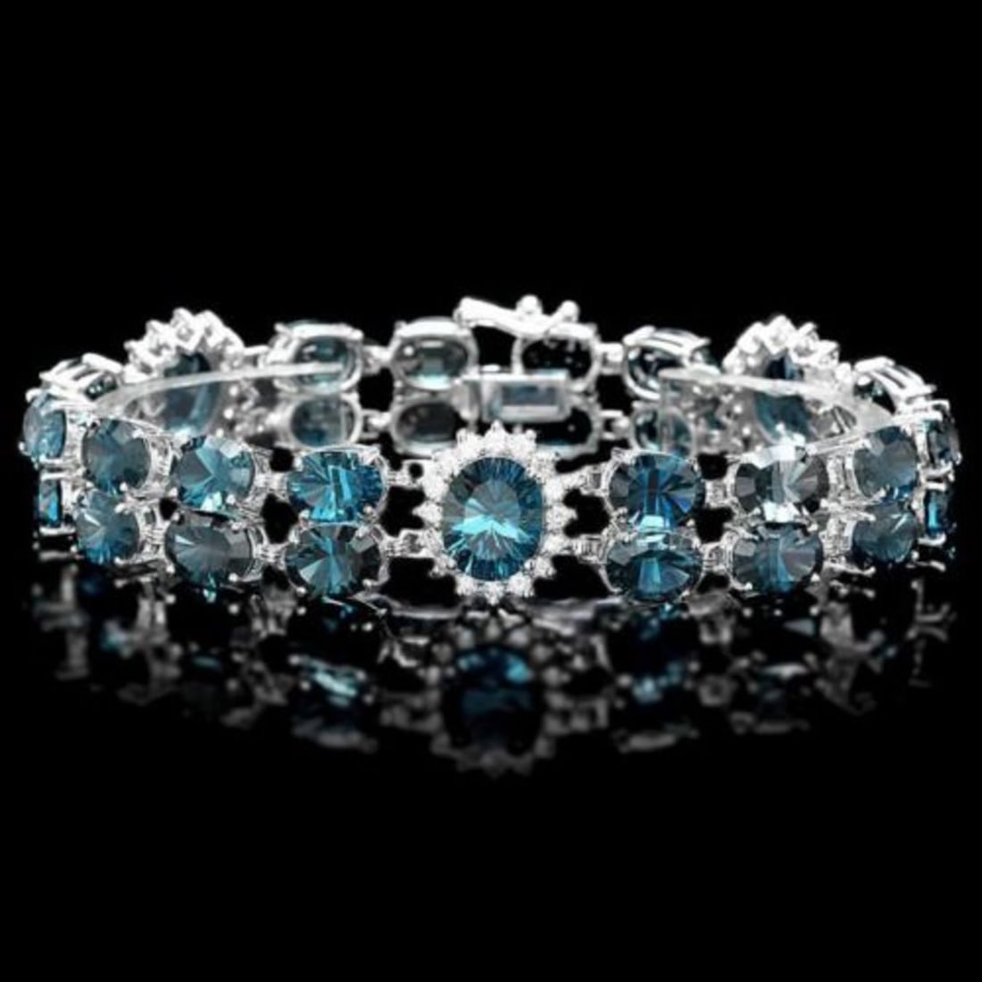 14K Gold 50.38ct Topaz 1.62ct Diamond Bracelet: Retail: $14,715.00 ****** 14K Gold 50.38ct Topaz 1.62ct Diamond Bracelet ****** Metal: 14G White Gold / Total Item Weight: 29.0 Grams / Country Made: United States / / Main Stone: Topaz / Color: Blue 