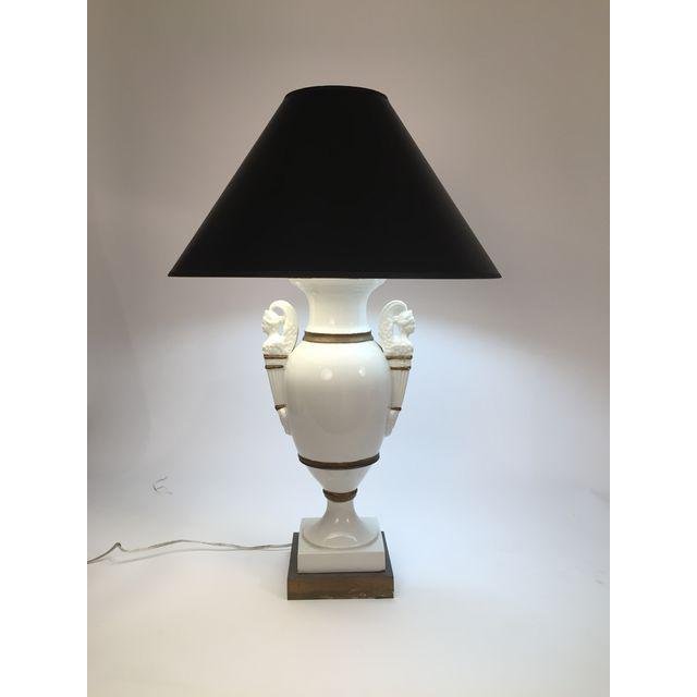 Antique Italian Porcelain Urn Lamp: Beautiful Italian antique porcelain urn lamp with gold painted detail and black shade. Base is wood. 2 light bulbs with string plus an on/off switch in the base of the lamp. This lamp will be a beauti