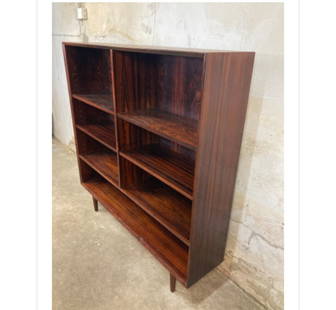 Mid-Century rosewood bookshelf: Mid-Century rosewood bookshelf with (2)-- Adjustable shelves on each section---Dimensions: Width---53 in.---Depth---12 in.--Height---53 in.