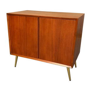 Mid-century curated teak cabinet with two open doors and brass legs.: Mid-century curated teak cabinet with two open doors and brass legs.