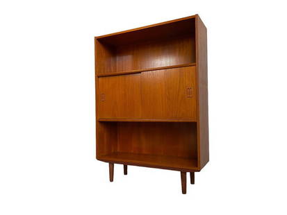 Mid Century Danish Teak bookcase with middle cabinet.: Dimensions: W:34 D:12 H:48 inches Mid Century Danish Teak bookcase with middle cabinet.