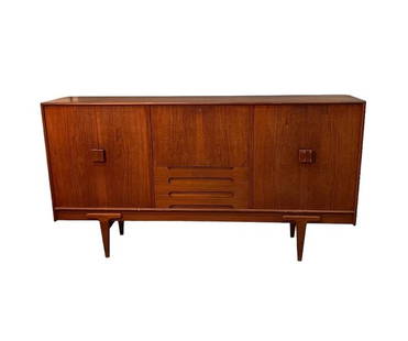 Mid-Century Ejvind A. Johanson teak high sideboard with middle desk section and storage 1960's: Dimensions: L:84 D:18 H:44 inches Mid-Century stunning tall teak sideboard with plenty of storage designed by Ejvind A. Johnson with middle desk section.