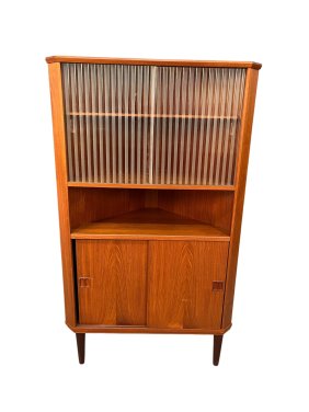This stunning mid-century teak and glass corner cabinet is sure to be a standout piece in any home.