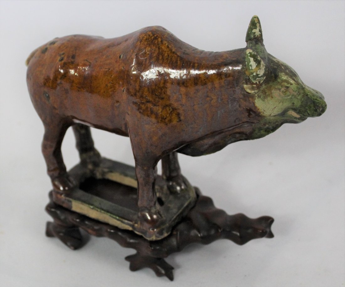 Chinese Tang Figurine: An antique Chinese porcelain tang period Sancai G laze Ox figurine. Dimensions: 4 x 6 inches.