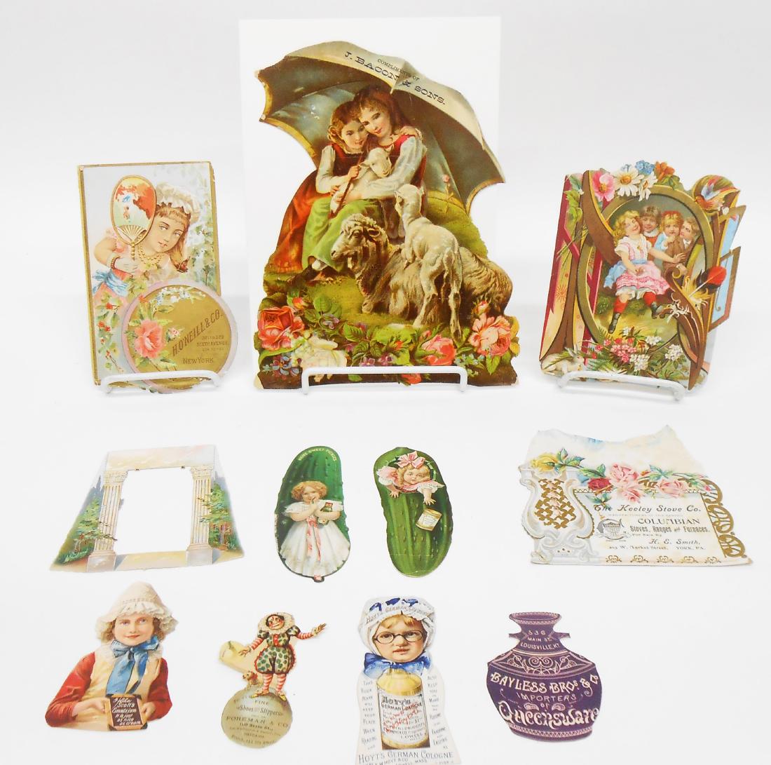 DIE-CUT CHROMO-LITHO ADVERTISING CARDS (11): Includes: (1) "The Keeley Stove Co." sold by H. E. Smith, York PA, embossed, with paper loss to rear, edge creasing; (1) H. O'Neill & Co. New York: edge bends, light litho loss and thin spots, origina