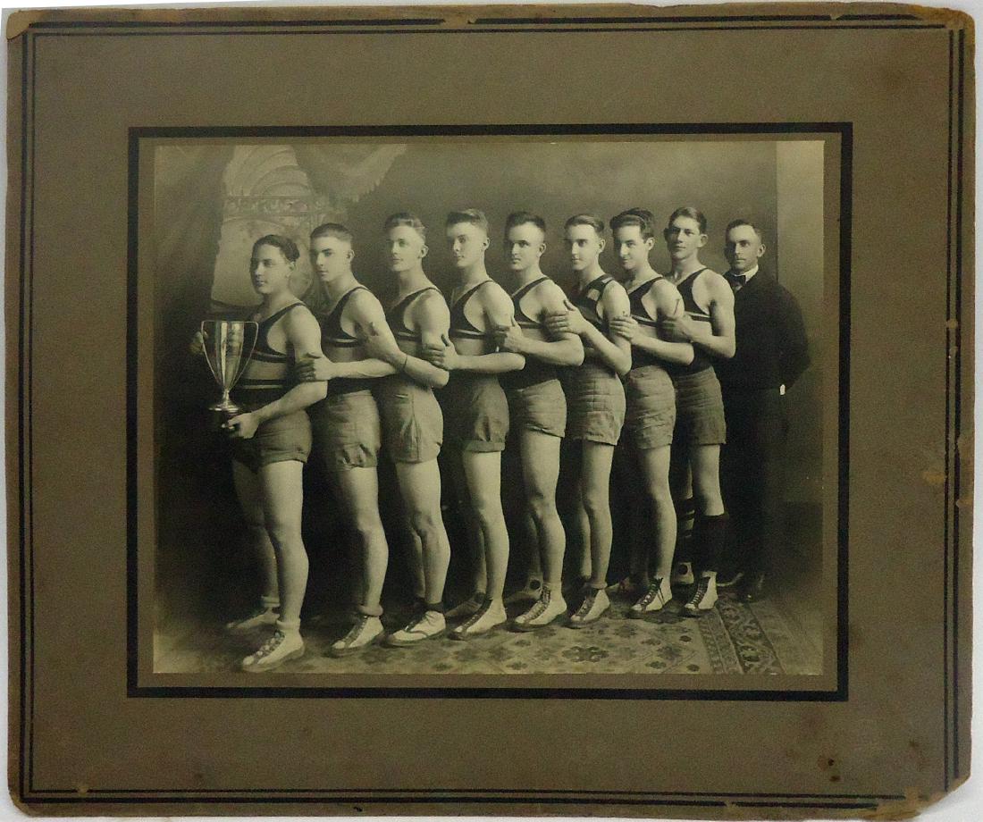 EARLY OKLAHOMA HIGH SCHOOL WRESTLING PHOTO: El Reno shuck; black and white, glued down to board; photo: minor scratches and spots; board has spotting, small tears; edges and corners rough; including board: 12" x 14", G-VG