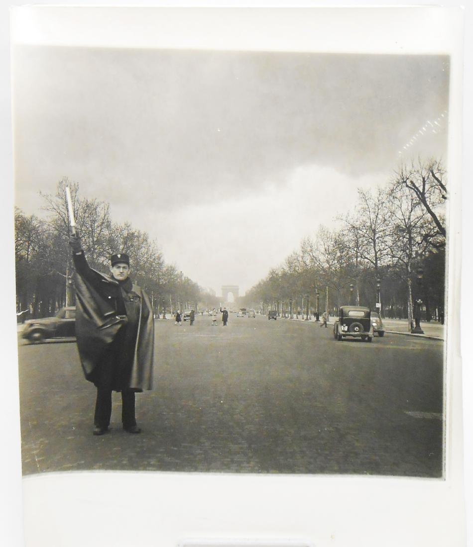 EDWARD CLARK CHAMPS ELYSEES PHOTO and LIFE MAGAZINE: Large scale photograph of gendarme (face forward) standing on the Champs Elysees with the Arc de Triomphe in the background, taken for a photo spread featured in Life Magazine, March 18, 1946. The iss