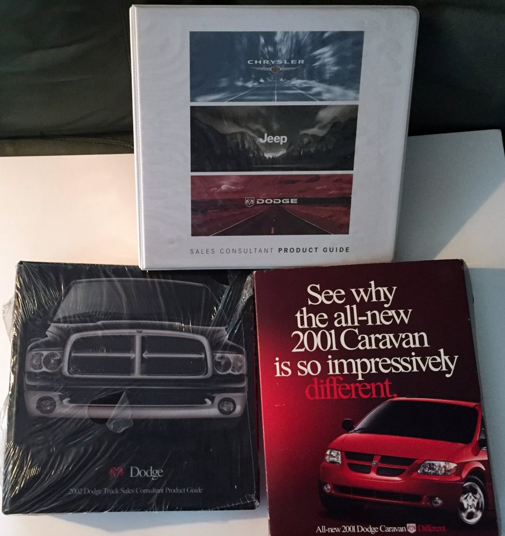 (3) DODGE DEALERSHIP REFERENCE BOOKS - MOPAR: Includes: (1) 2002 Dodge Truck Sales Consultant Product Guide, pages still sealed in plastic; (1) 2001 Dodge Caravan Sales stimulator, litho cardboard sleeve containing book, VHS tape and DVD, sleeve 