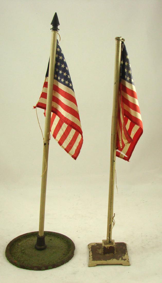 (2) STANDARD GAUGE LIONEL FLAGS: flag pole and flag staff, #89 and #90; some paint loss and rust; silk flags have some small holes, tear and stains; H-14", F-G