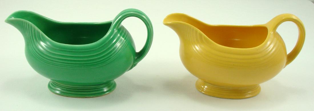 (2) VINTAGE FIESTA SAUCE BOATS: Yellow and green; both with impressed "HLC (monogram) Fiesta Made in USA" mark; yellow boat has irregular shaped lip, glazed over, so likely a production flaw; L-8", EX