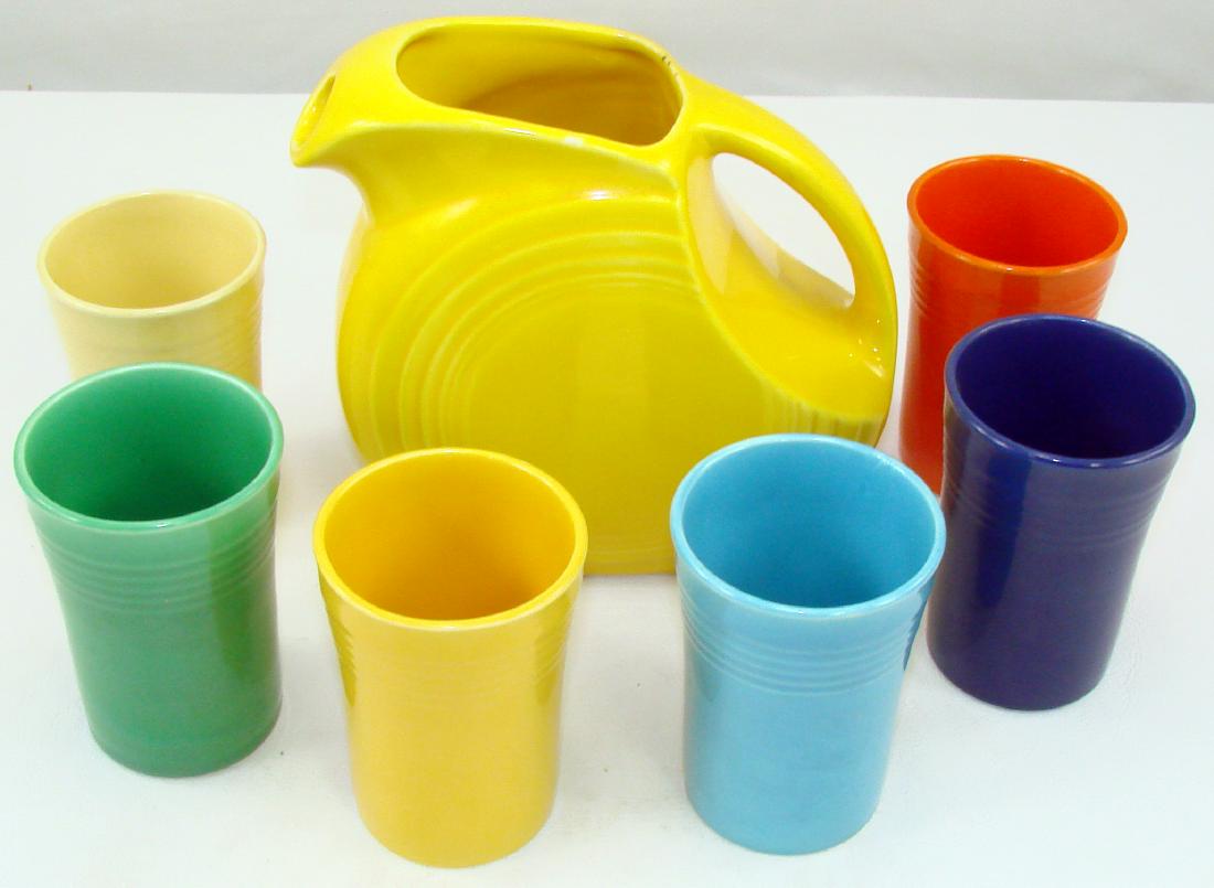 VINTAGE (7) PIECE FIESTA JUICE SET: Includes: yellow juice pitcher and (6) juice tumblers, in each of the original six colors; pitcher has dark imperfections along rim; pitcher impressed "HLC (monogram) Fiesta Made in USA"; pitcher H-5 