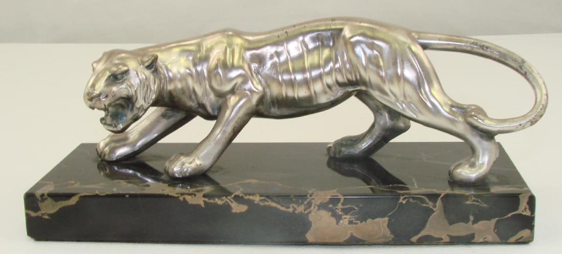 ART DECO PAPER WEIGHT / DESK ORNAMENT: Spelter figure of stalking tiger with silver finish, mounted to black marble base; felted bottom; very minor swear and spotting to silver finish; L-7 7/8", H-3 1/2", VG+
